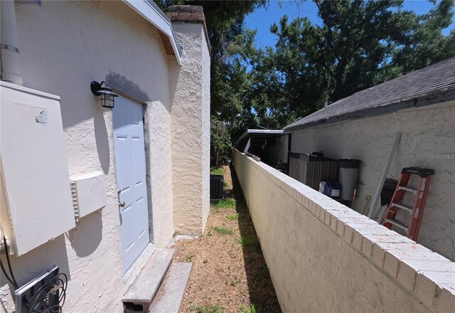 4607 N 35th St, Tampa, FL 33610 - view of property exterior with fence, stucco siding, and central AC unit
