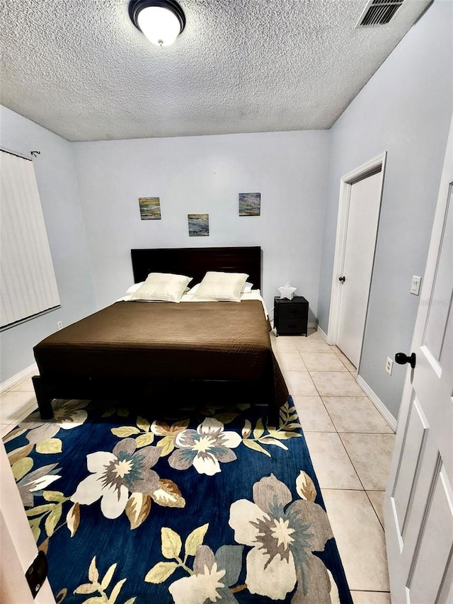 13140 Summerton Dr, Orlando, FL 32824 - bedroom with a textured ceiling and light tile patterned floors