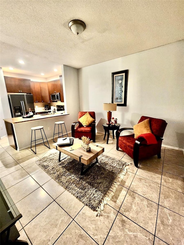 13140 Summerton Dr, Orlando, FL 32824 - living area with a textured ceiling, recessed lighting, light tile patterned floors, and baseboards