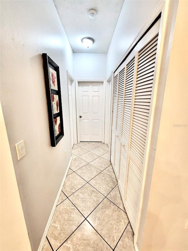 13140 Summerton Dr, Orlando, FL 32824 - hall with light tile patterned flooring, baseboards, a heating unit, and a textured ceiling