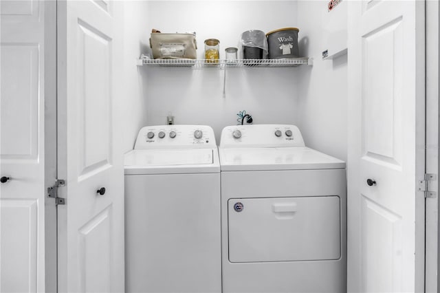 clothes washing area with washer and dryer