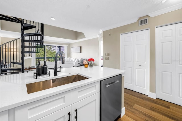 kitchen with dishwasher, a sink, crown molding, white cabinetry, and wood finished floors