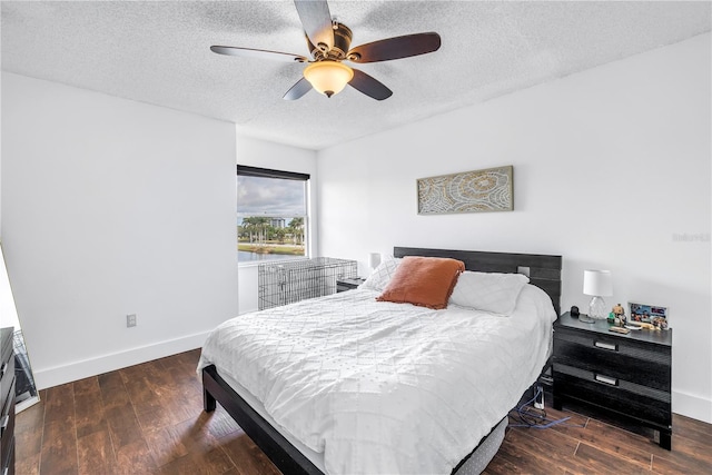 bedroom with a textured ceiling, wood finished floors, baseboards, and a ceiling fan