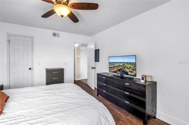 bedroom with dark wood finished floors, baseboards, and a ceiling fan
