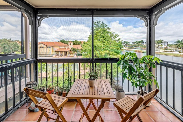 sunroom with a water view and plenty of natural light