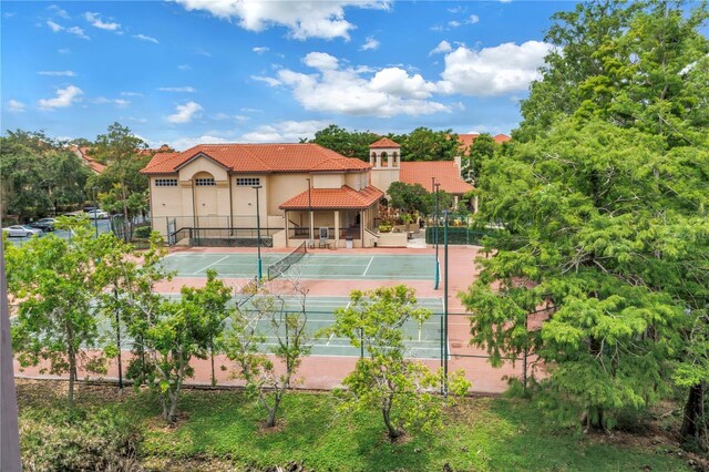 view of tennis court featuring fence