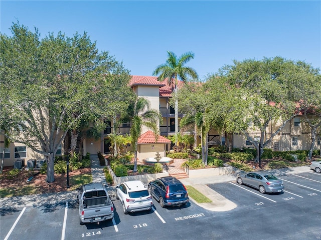 view of building exterior with uncovered parking