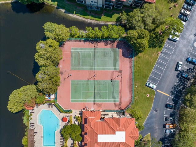 aerial view of a pool and a nearby body of water