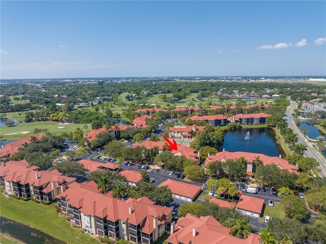 aerial view of residential area with a nearby body of water and a golf course
