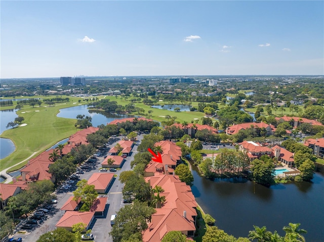 aerial perspective of suburban area with a local golf course and a nearby body of water