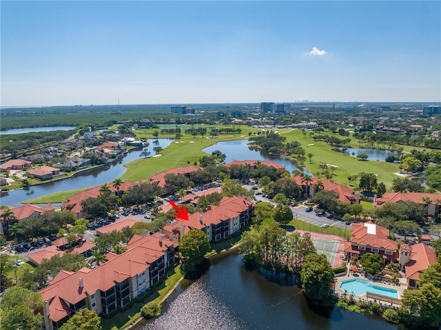 aerial perspective of suburban area with a golf course and a large body of water