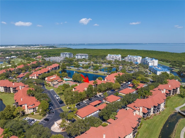 drone / aerial view of a large body of water and apartment complex