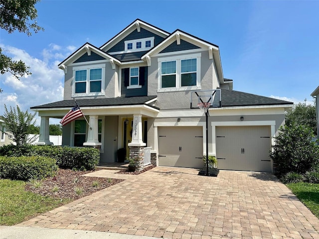 12327 Eagle Swoop Pl, Riverview, FL 33579 - craftsman-style home with a porch, stucco siding, decorative driveway, and roof with shingles
