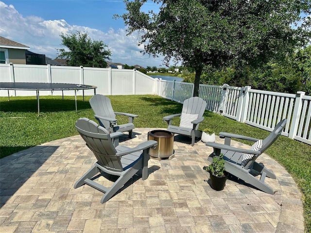 12327 Eagle Swoop Pl, Riverview, FL 33579 - view of patio / terrace featuring an outdoor fire pit and a trampoline