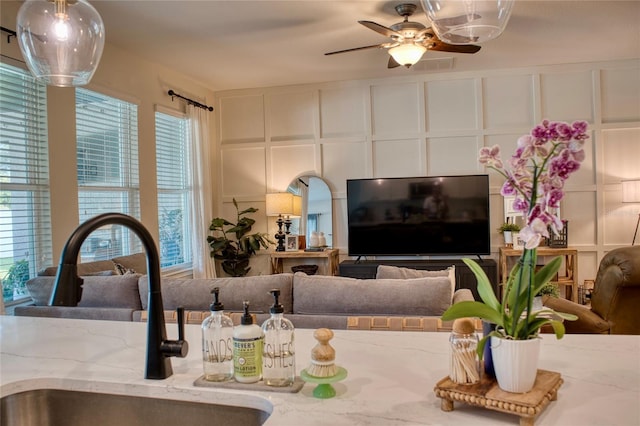 12327 Eagle Swoop Pl, Riverview, FL 33579 - living area featuring a decorative wall, a ceiling fan, and plenty of natural light