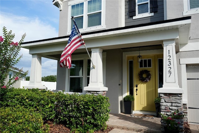 12327 Eagle Swoop Pl, Riverview, FL 33579 - property entrance with stucco siding and covered porch