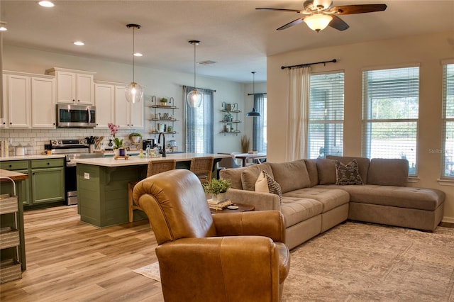12327 Eagle Swoop Pl, Riverview, FL 33579 - living area with ceiling fan, light wood finished floors, and recessed lighting