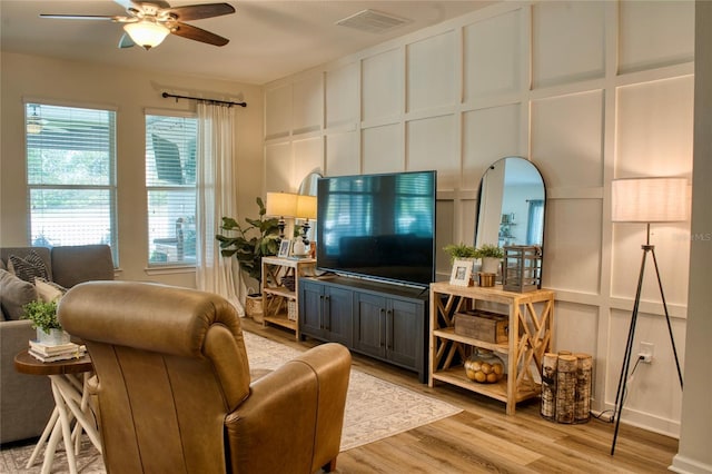 12327 Eagle Swoop Pl, Riverview, FL 33579 - living area featuring a ceiling fan, light wood finished floors, and a decorative wall