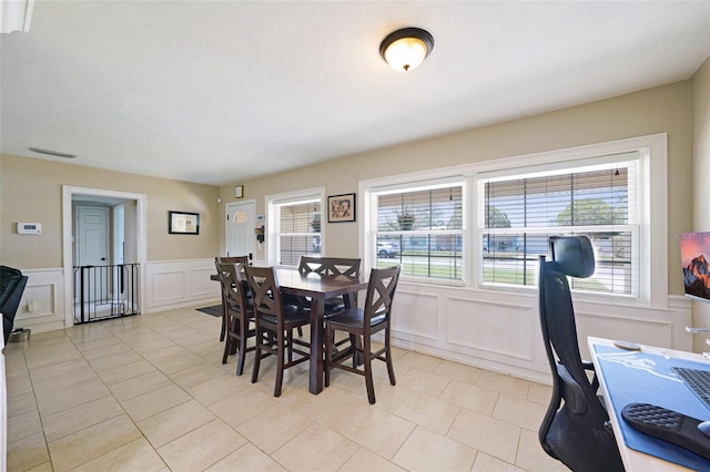 1450 Seabreeze St, Clearwater, FL 33756 - dining room featuring a decorative wall, wainscoting, and light tile patterned flooring