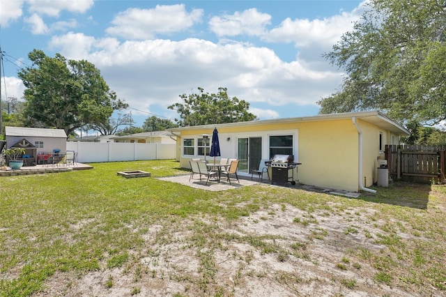 1450 Seabreeze St, Clearwater, FL 33756 - back of property featuring an outdoor fire pit, a patio, and stucco siding