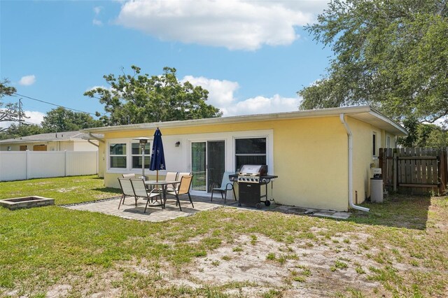 1450 Seabreeze St, Clearwater, FL 33756 - back of property with stucco siding and a patio