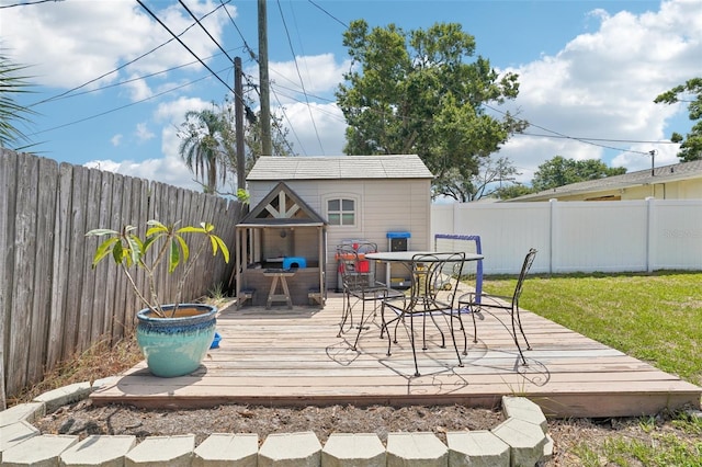 1450 Seabreeze St, Clearwater, FL 33756 - wooden deck featuring outdoor dining area and an outbuilding