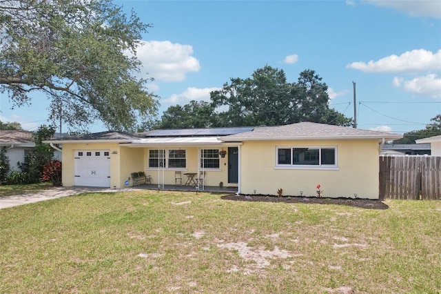 1450 Seabreeze St, Clearwater, FL 33756 - ranch-style home with a garage, solar panels, concrete driveway, a porch, and stucco siding