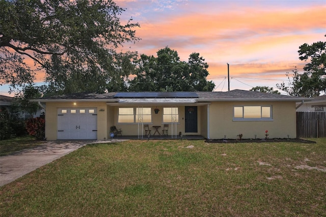1450 Seabreeze St, Clearwater, FL 33756 - ranch-style home featuring covered porch, an attached garage, concrete driveway, and solar panels