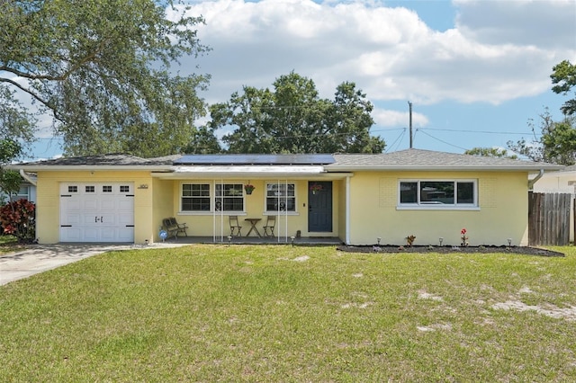 1450 Seabreeze St, Clearwater, FL 33756 - single story home with a garage, roof mounted solar panels, driveway, and stucco siding