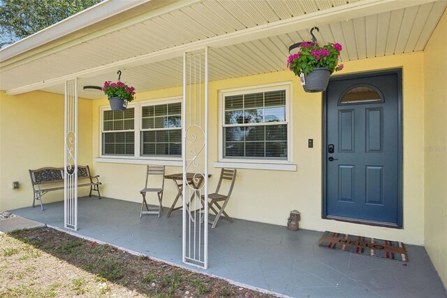 1450 Seabreeze St, Clearwater, FL 33756 - doorway to property with a porch and stucco siding