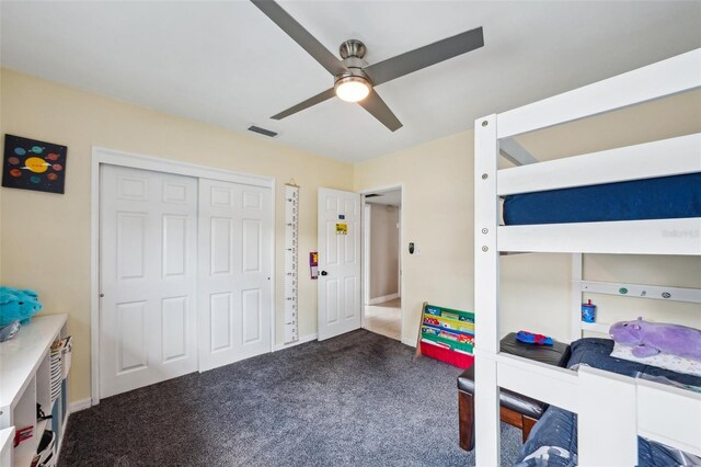 1450 Seabreeze St, Clearwater, FL 33756 - bedroom with dark carpet, a closet, ceiling fan, and baseboards