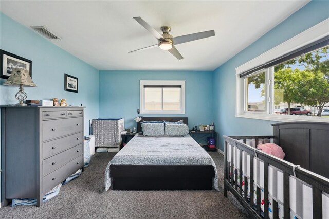 1450 Seabreeze St, Clearwater, FL 33756 - carpeted bedroom featuring multiple windows and a ceiling fan