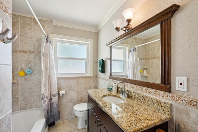 1450 Seabreeze St, Clearwater, FL 33756 - full bathroom featuring tile walls, vanity, plenty of natural light, toilet, and shower / bath combo