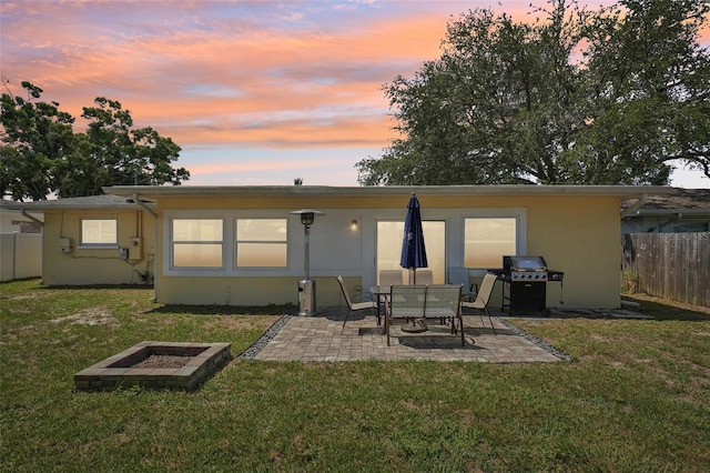 1450 Seabreeze St, Clearwater, FL 33756 - back of property at dusk featuring a patio and stucco siding