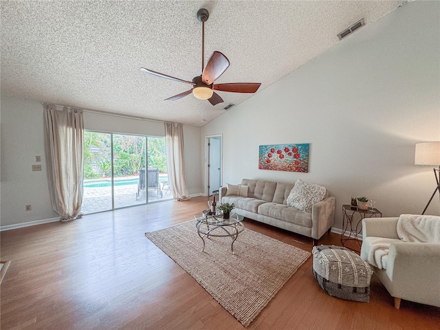1955 Cobblestone Way, Clearwater, FL 33760 - living room with a ceiling fan, a textured ceiling, wood finished floors, and lofted ceiling
