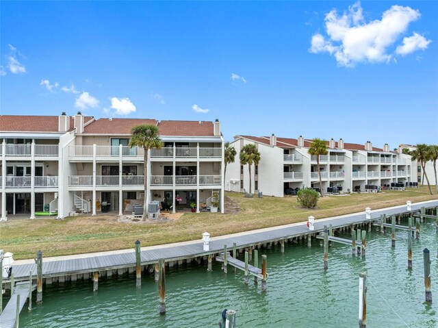 12360 Capri Cir N Unit 106, Treasure Island, FL 33706 - dock area featuring a water view and a yard