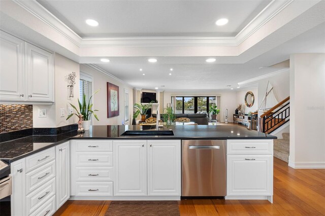 12360 Capri Cir N Unit 106, Treasure Island, FL 33706 - kitchen with dishwasher, a sink, crown molding, light wood-type flooring, and white cabinets