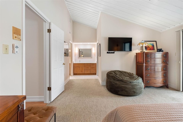 12360 Capri Cir N Unit 106, Treasure Island, FL 33706 - bedroom featuring vaulted ceiling, light carpet, ensuite bath, baseboards, and wooden ceiling