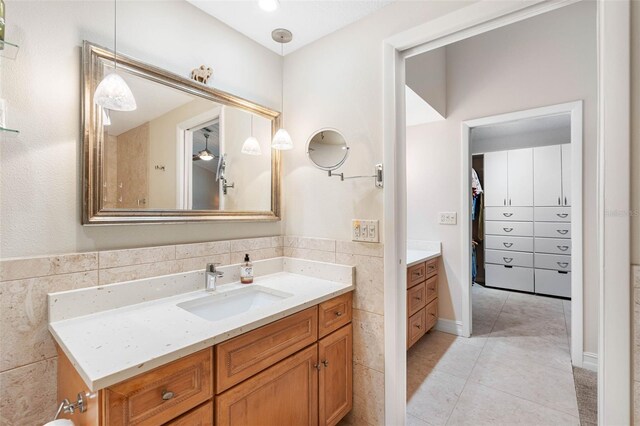 12360 Capri Cir N Unit 106, Treasure Island, FL 33706 - full bathroom featuring vanity, tile patterned flooring, and a spacious closet