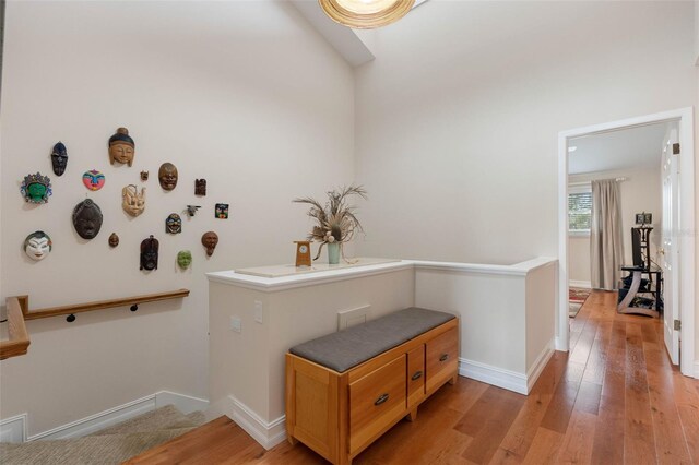 12360 Capri Cir N Unit 106, Treasure Island, FL 33706 - hall featuring an upstairs landing, light wood-style flooring, and baseboards