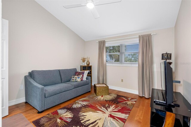 12360 Capri Cir N Unit 106, Treasure Island, FL 33706 - living room featuring lofted ceiling, wood finished floors, a ceiling fan, and baseboards