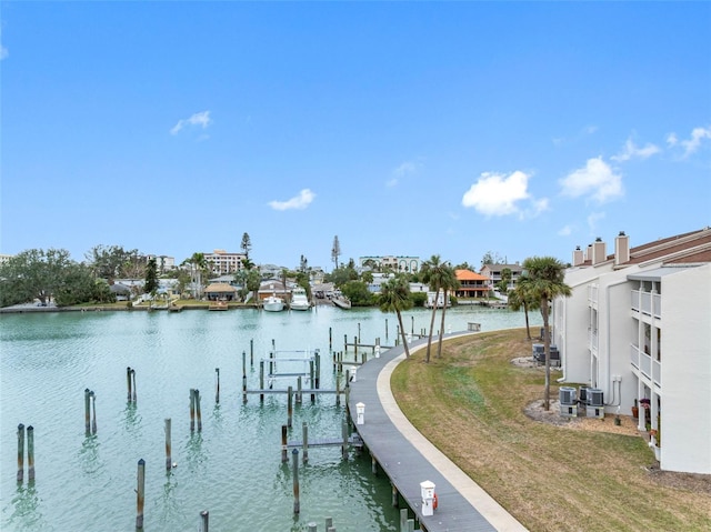 12360 Capri Cir N Unit 106, Treasure Island, FL 33706 - dock area featuring a water view, a lawn, and central air condition unit