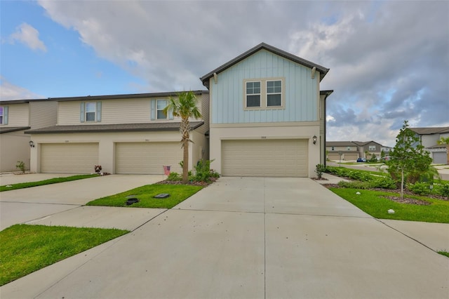 7709 Imagination Pl, Wesley Chapel, FL 33545 - view of front facade with a garage, board and batten siding, and driveway