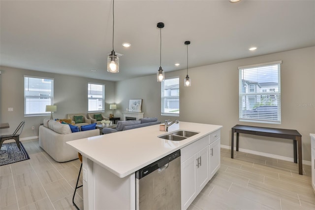 7709 Imagination Pl, Wesley Chapel, FL 33545 - kitchen featuring a sink, dishwasher, recessed lighting, light countertops, and white cabinets