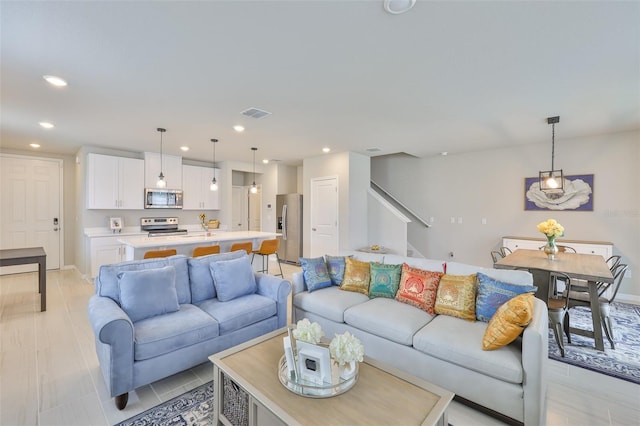 7709 Imagination Pl, Wesley Chapel, FL 33545 - living area with recessed lighting, stairway, and baseboards