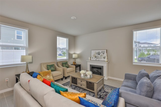 7709 Imagination Pl, Wesley Chapel, FL 33545 - living area featuring baseboards, a fireplace, and tile patterned flooring
