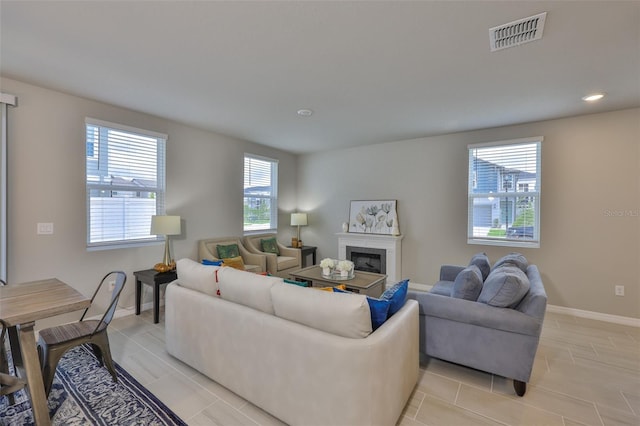 7709 Imagination Pl, Wesley Chapel, FL 33545 - living area with a fireplace, baseboards, and recessed lighting