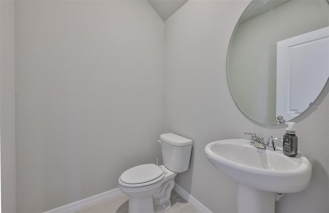 7709 Imagination Pl, Wesley Chapel, FL 33545 - half bathroom with toilet, baseboards, tile patterned flooring, and a sink