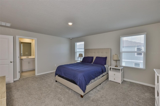 7709 Imagination Pl, Wesley Chapel, FL 33545 - bedroom featuring carpet flooring, baseboards, ensuite bathroom, and a textured ceiling