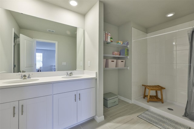 7709 Imagination Pl, Wesley Chapel, FL 33545 - full bath featuring double vanity, a tile shower, recessed lighting, and tile patterned floors